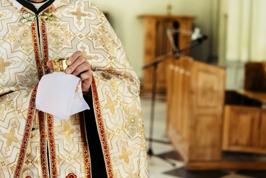 priest holding chalice for communion